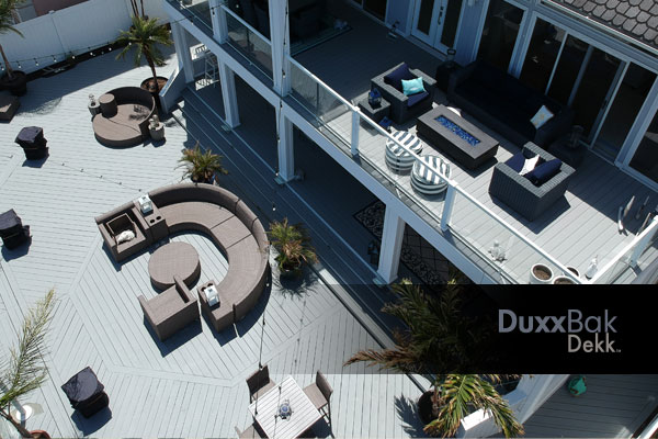 Image of a residential application with multi level decks showing an upper deck of Duxxbak Dekk water shedding composite.