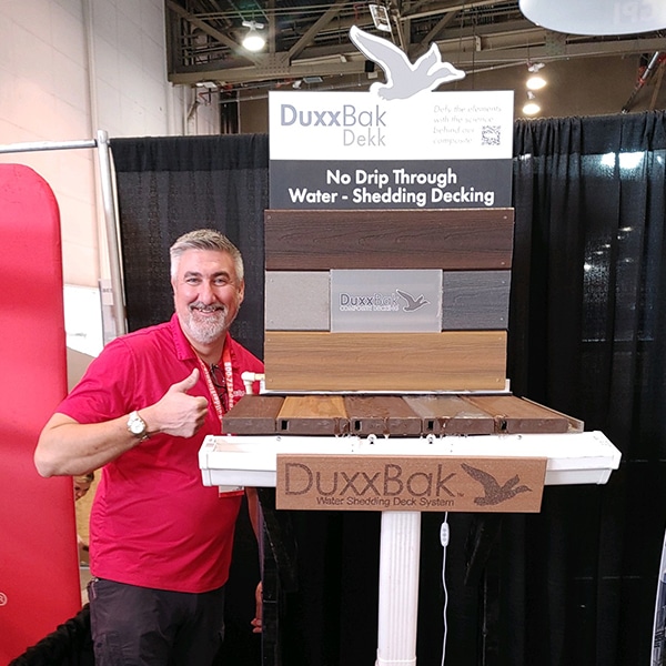 Image of the DuxxBak Dekk Display and DuxxBak Composite Decking President, Brandon Beard, at the IBS Show 2024 in Las Vegas.