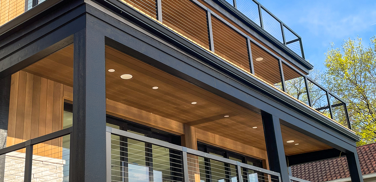 elegant two-story deck with DuxxBak decking and dark and light wood tones